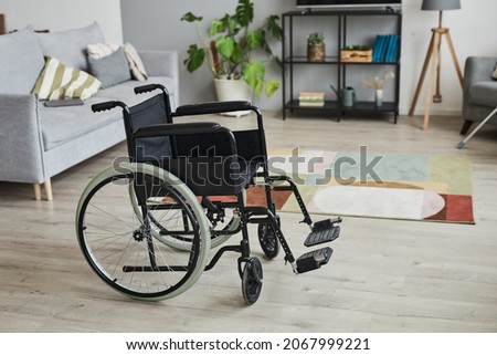 Full length background image of empty wheelchair in home interior, copy space
