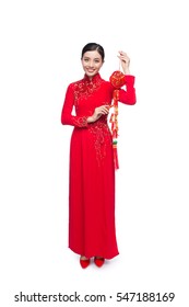 Full length of a beautiful Asian woman on traditional festival costume Ao Dai. Tet holiday. Lunar New Year. Text mean Lucky and Happiness.