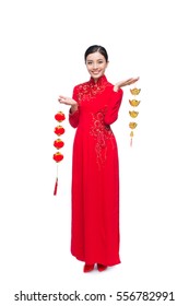 Full length of a beautiful Asian woman on traditional festival costume Ao Dai. Tet holiday. Lunar New Year.
