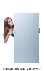 Full Length Of Beautiful Woman Standing Behind, Holding  Blank Advertising Board Banner, Over White Background