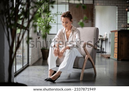 Similar – Woman in work wear in her workshop by table with handmade items