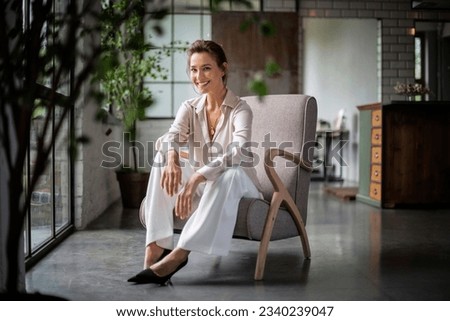 Similar – Image, Stock Photo Young female sitting by table and making clay or ceramic mug