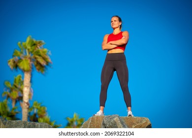 Full Length Body Beautiful Blonde Caucasian Woman Arms Crossed Yoga Pants Strong Muscular Fit Looking Into Distance Good Figure Healthy Lifestyle Runner Determination Focus After 
Before Workout