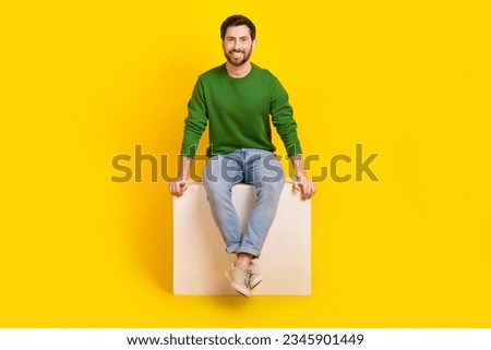 Full length body photo of cheerful young satisfied marketolog businessman guy sitting white box podium isolated on yellow color background
