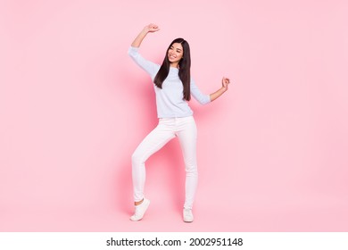 Full length body size of cheerful woman dancing at party looking copyspace isolated on pastel pink color background Stockfoto