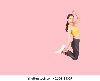 Full length body size of Cheerful woman jumping to the air wearing sportswear with excited face Isolated on pink background and copy space Health care Healthy Lifestyle Exercise and Workout concept - Shutterstock ID 2184413387