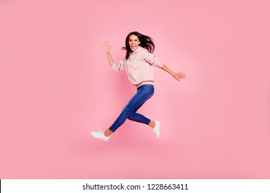 Full length body size of nice foolish childish girlish lovely attractive sweet charming cheerful positive girl running fast in air having fun isolated over pastel pink background