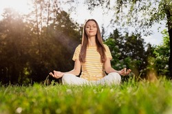 Full Length Body Size Photo Woman Sitting On Grass Practising Yoga Excercises In Summer Park