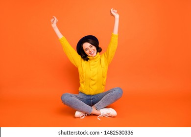 Full length body size photo of rejoicing overjoyed cheerful girl isolated over orange background