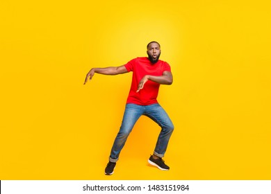 Full Length Body Size Photo Of Black Man Dancing With Face Serious While Isolated With Yellow Background