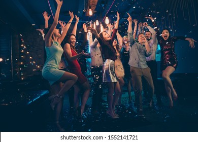 Full Length Body Size Photo Of Company Dancing Cheerfully At Night Club Under Falling Confetti And Light Of Shining Lamps With Smiles On Their Faces