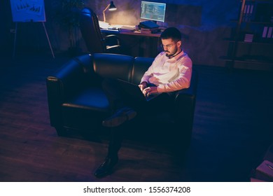 Full length body size photo of concentrated focused man sitting with laptop writing code to new software in spectacles - Shutterstock ID 1556374208