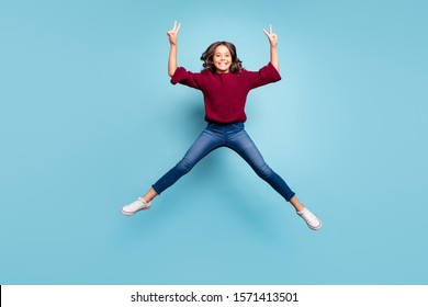 Full length body size photo of cheerful positive preteen showning you double v-sign in brugundy knitted sweater smiling toothily isolated vivid color blue background - Shutterstock ID 1571413501