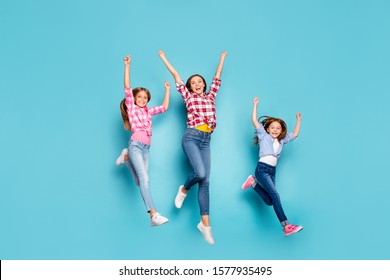 Full Length Body Size Photo Of Cheerful Friendly White Family Enjoying Pin-up Winning Running Competitions While Isolated With Blue Background Wearing Jeans Denim