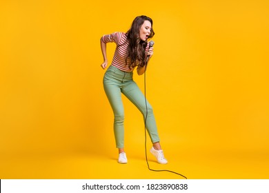 Full length body size photo of female pop star singing song on stage festival isolated on bright yellow color background - Shutterstock ID 1823890838