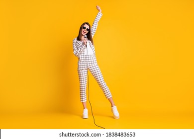 Full Length Body Size Photo Of Girl Holding Mic Singing Song On Concert Stage Wearing Sunglass Isolated On Vibrant Yellow Color Background