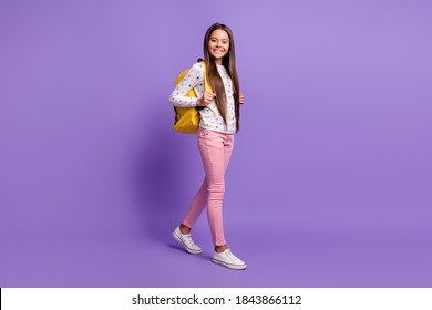 Full Length Body Size Photo Of Preteen Girl With Long Hair Carrying Yellow Backpack Smiling Happily Isolated On Bright Violet Background