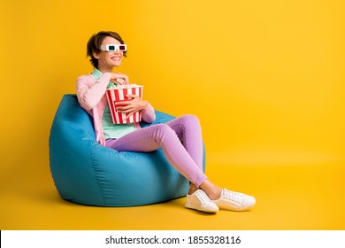 Full length body size photo woman 3d glasses watching comedy tv eating pop corn beanbag isolated on bright yellow color background copyspace