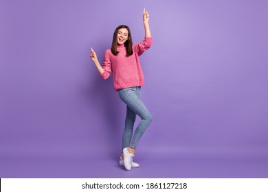 Full length body size photo of cheerful dancing at disco smiling moving woman isolated on vibrant purple color background