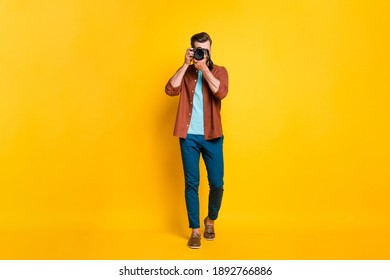 Full Length Body Size Photo Of Bearded Millennial Taking Photo With Professional Camera Isolated On Bright Yellow Color Background