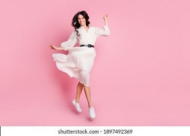 Full length body size photo of girlish cheerful woman in long dress jumping stepping smiling isolated pastel pink color background - Shutterstock ID 1897492369