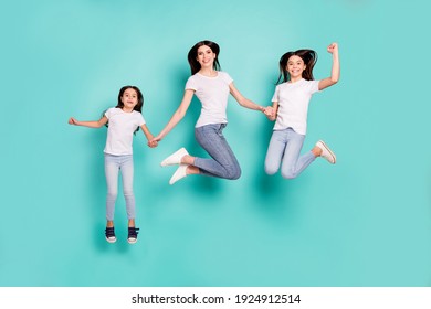 Full length body size photo sisters jumping up wearing jeans white t-shirts happy won lottery isolated bright blue color background - Shutterstock ID 1924912514
