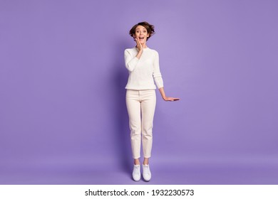 Full length body size photo of cheerful girl jumping in white outfit isolated on bright purple color background
