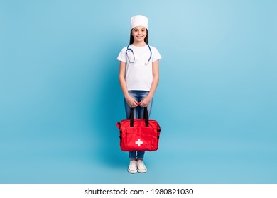 Full Length Body Size Photo Of Little Female Doctor Working In Ambulance Smiling Keeping Red Bag Isolated On Bright Blue Color Background