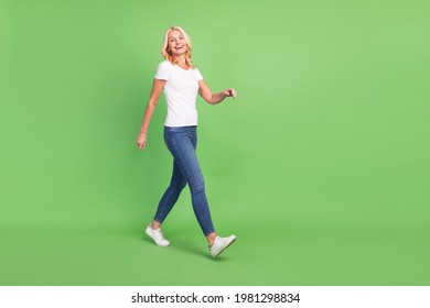 Full Length Body Size Photo Senior Woman Walking On Meeting Laughing Isolated On Pastel Green Color Background Copyspace