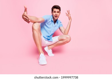 Full Length Body Size Photo Smiling Man In Blue Shirt Sitting Dancing Gesturing Hands Isolated Pastel Pink Color Background