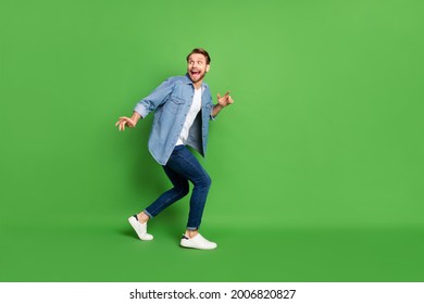 Full length body size photo of thief sneaking away looking back isolated vivid green color background - Shutterstock ID 2006820827