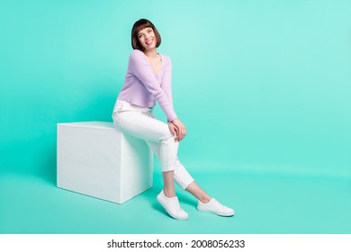 Full length body size photo woman sitting wearing casual outfit smiling cheerful isolated bright turquoise color background - Shutterstock ID 2008056233