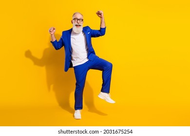 Full Length Body Size Photo Of Bearded Senior Man In Stylish Outfit Gesturing Like Winner Isolated On Vivid Yellow Color Background