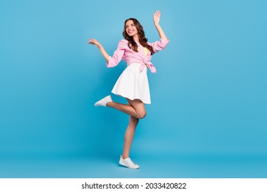 Full length body size photo woman smiling dancing at party looking copyspace isolated pastel blue color background