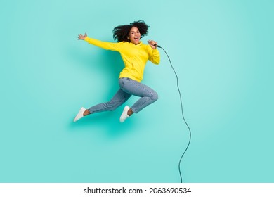 Full Length Body Size Photo Woman Jumping Up Singing In Microphone Isolated Bright Teal Color Background