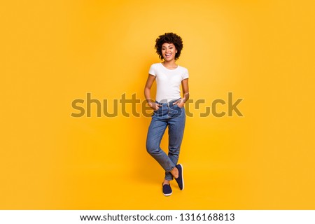 Full length body size photo beautiful amazing she her dark skin lady lovely look self-confident optimistic nice cool wear casual white t-shirt isolated yellow bright vibrant vivid background
