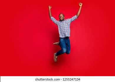 Full length body size portrait of nice funny glad handsome cheerful optimistic positive guy wearing checkered shirt raising hands up party in air isolated on bright vivid shine red background - Shutterstock ID 1255247134