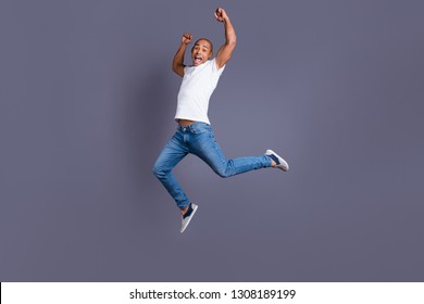 Full length body size portrait of his he nice handsome attractive muscular strong cheerful cheery crazy guy in white shirt jeans having fun great cool triumph isolated over gray background - Shutterstock ID 1308189199