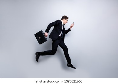 Full length body size profile side view portrait of his he nice classy attractive nervous worried guy carrying in hands diplomat cell white collar rush hour career growth isolated on light gray - Powered by Shutterstock