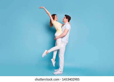 Full length body size profile side view of nice attractive cheerful spouses wearing casual having fun time spending honey moon vacation isolated over bright vivid shine blue green background - Shutterstock ID 1453402985
