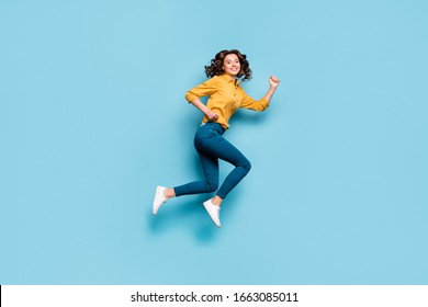 Full length body size profile side view of nice sportive cheerful wavy-haired girl jumping running fast life inspiration isolated on bright vivid shine vibrant green blue turquoise color background