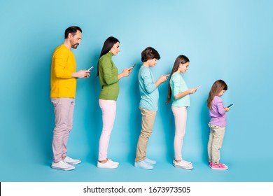 Full length body size profile side view of nice attractive addicted focused big full family using digital device browsing internet online isolated on bright vivid shine vibrant blue color background