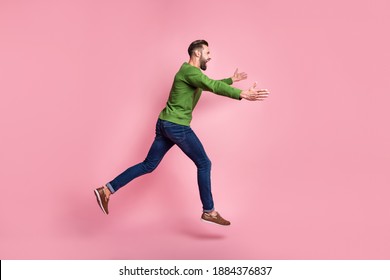 Full length body size profile side view of nice cheerful guy jumping running hugging copy space isolated over pink pastel color background