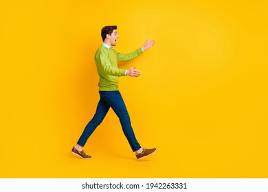 Full length body size profile side view of nice cheerful guy walking meeting hugging invisible friend isolated over bright yellow color background