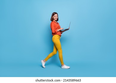 Full length body size profile side view of attractive cheery girl going using laptop isolated over bright blue color background - Shutterstock ID 2143589663