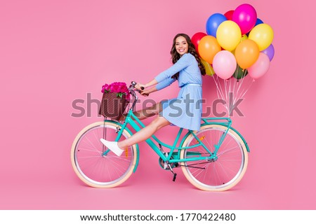 Full length body size profile side view of attractive cheerful cheery wavy-haired lady riding bike without legs delivering decoration event having fun isolated pink pastel color background