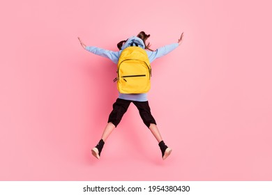 Full length body size rear back behind view of nice girl jumping new academic school year isolated over pink pastel color background - Shutterstock ID 1954380430