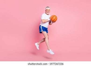 Full Length Body Size Side Profile Photo Senior Man Jumping Up Playing Basketball Smiling Isolated Pastel Pink Color Background