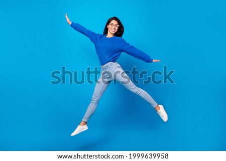 Full length body size side profile photo young woman jumping up careless isolated vibrant blue color background