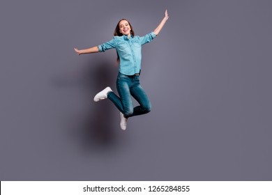 Full Length Body Size Studio Photo Portrait Of Funny Funky Overjoyed Pretty Lovely Nice Careless Glad Cheerful Pretty Student Teen In Denim Shirt Jumping Up Isolated Grey Background